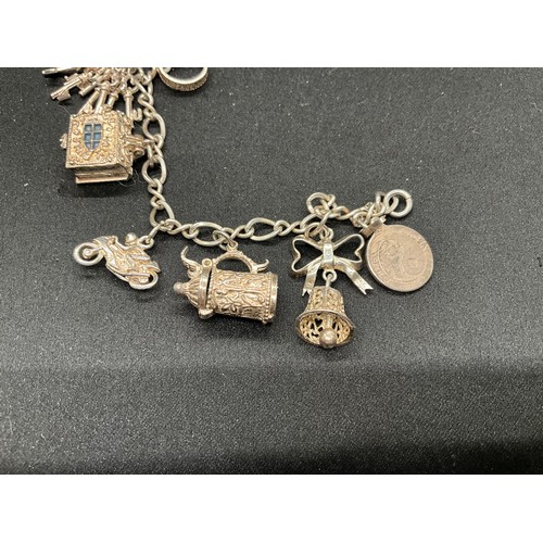 42 - 2 SILVER CHARM BRACELETS (TESTED)WITH A TOTAL OF 24 SILVER & WHITE METAL CHARMS TW78.8G
1 BRACELET H... 