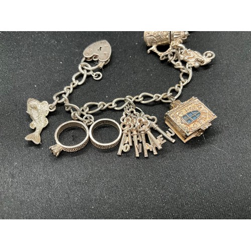 42 - 2 SILVER CHARM BRACELETS (TESTED)WITH A TOTAL OF 24 SILVER & WHITE METAL CHARMS TW78.8G
1 BRACELET H... 