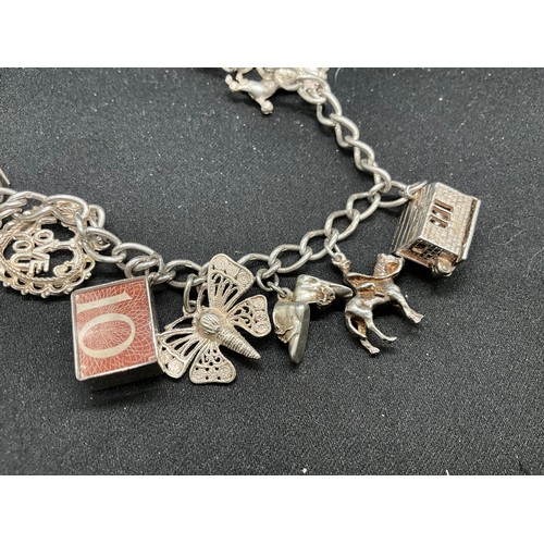 42 - 2 SILVER CHARM BRACELETS (TESTED)WITH A TOTAL OF 24 SILVER & WHITE METAL CHARMS TW78.8G
1 BRACELET H... 