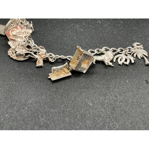 42 - 2 SILVER CHARM BRACELETS (TESTED)WITH A TOTAL OF 24 SILVER & WHITE METAL CHARMS TW78.8G
1 BRACELET H... 
