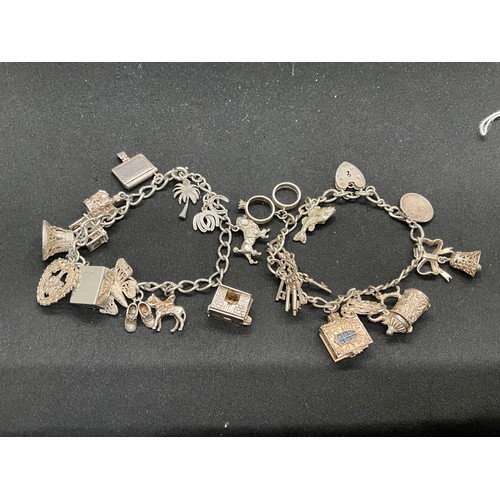 42 - 2 SILVER CHARM BRACELETS (TESTED)WITH A TOTAL OF 24 SILVER & WHITE METAL CHARMS TW78.8G
1 BRACELET H... 
