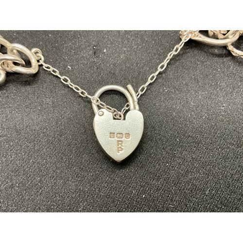 43 - SILVER CHARM BRACELET (TESTED) WITH 24 SILVER CHARMS TW54G 2 CHARMS HELD IN PLACE WITH PLATED HOOPS ... 