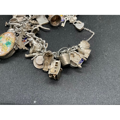 44 - SILVER CHARM BRACELET (TESTED) WITH 39 SILVER & WHITE METAL CHARMS 1 ADDITIONAL CHARM IS BRACELET W1... 