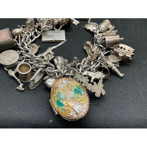44 - SILVER CHARM BRACELET (TESTED) WITH 39 SILVER & WHITE METAL CHARMS 1 ADDITIONAL CHARM IS BRACELET W1... 