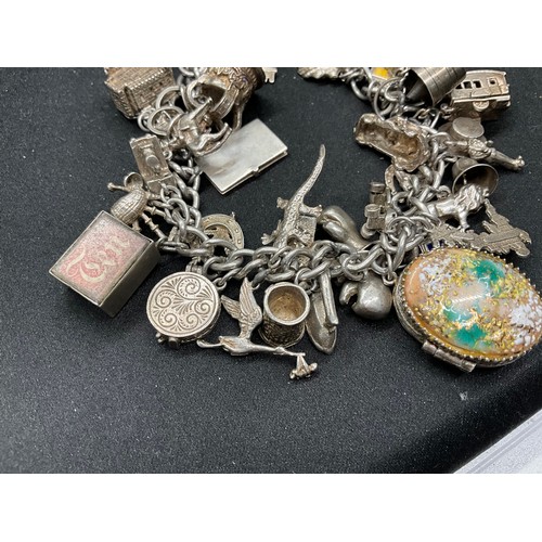 44 - SILVER CHARM BRACELET (TESTED) WITH 39 SILVER & WHITE METAL CHARMS 1 ADDITIONAL CHARM IS BRACELET W1... 