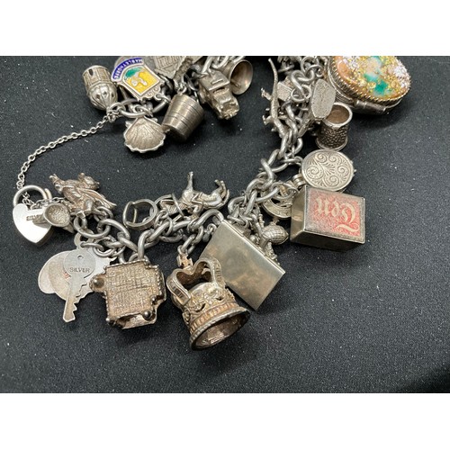 44 - SILVER CHARM BRACELET (TESTED) WITH 39 SILVER & WHITE METAL CHARMS 1 ADDITIONAL CHARM IS BRACELET W1... 