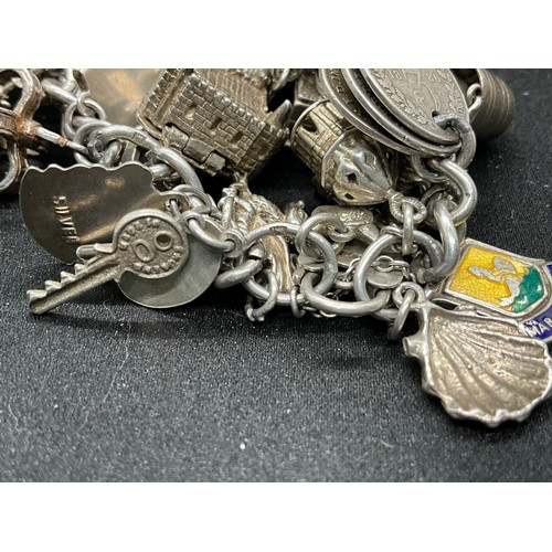 44 - SILVER CHARM BRACELET (TESTED) WITH 39 SILVER & WHITE METAL CHARMS 1 ADDITIONAL CHARM IS BRACELET W1... 