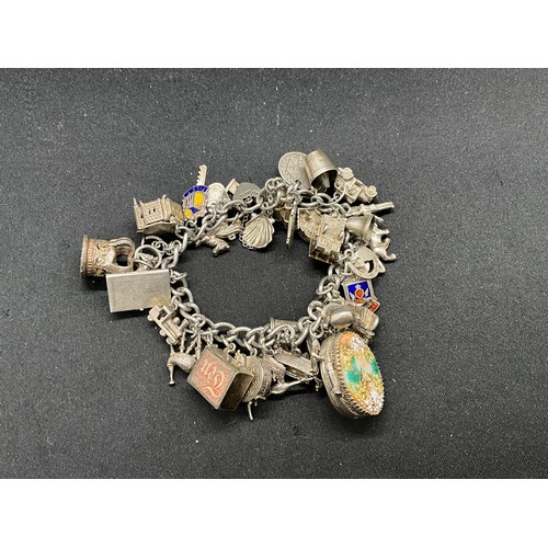 44 - SILVER CHARM BRACELET (TESTED) WITH 39 SILVER & WHITE METAL CHARMS 1 ADDITIONAL CHARM IS BRACELET W1... 