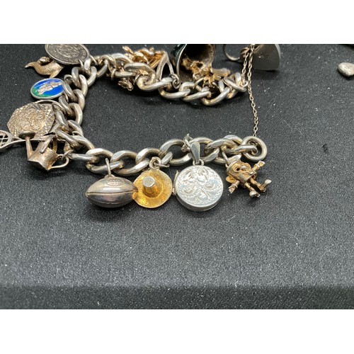 45 - 2 SILVER CHARM BRACLETS (TESTED) WITH A TOTAL OF 24 SILVER CHARMS TW83.7G
1 BRACELET HAS ENGLISH HAL... 