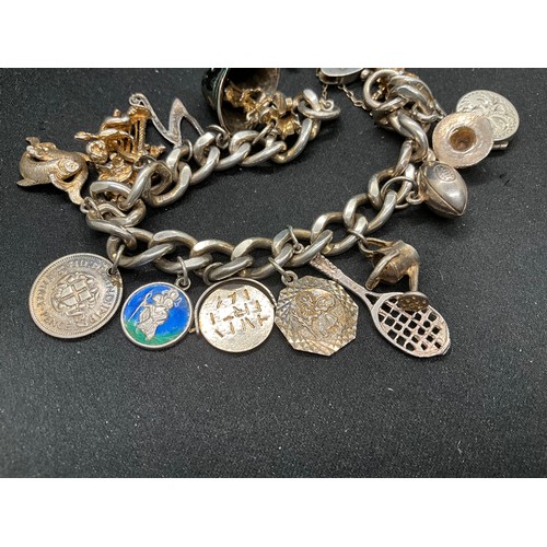 45 - 2 SILVER CHARM BRACLETS (TESTED) WITH A TOTAL OF 24 SILVER CHARMS TW83.7G
1 BRACELET HAS ENGLISH HAL... 
