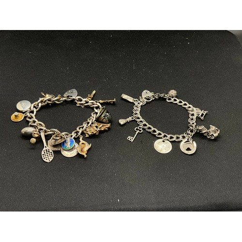 45 - 2 SILVER CHARM BRACLETS (TESTED) WITH A TOTAL OF 24 SILVER CHARMS TW83.7G
1 BRACELET HAS ENGLISH HAL... 