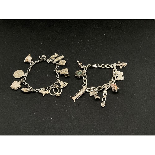 46 - 2 SILVER CHARM BRACELETS (TESTED) WITH A TOTAL OF 20 SILVER CHARMS TW49.1G
1 LOBSTER CLASP ON ONE BR... 