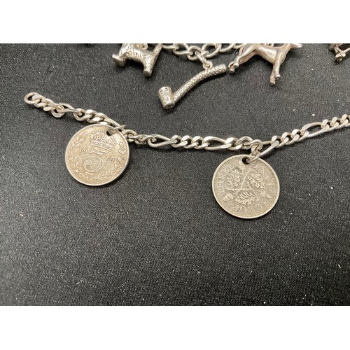 47 - 2 STERLING SILVER CHARM BRACELETS WITH 17 SILVER CHARMS W36.1G
CLASP ON ONE BRACELET IS PLATED, LOCK... 