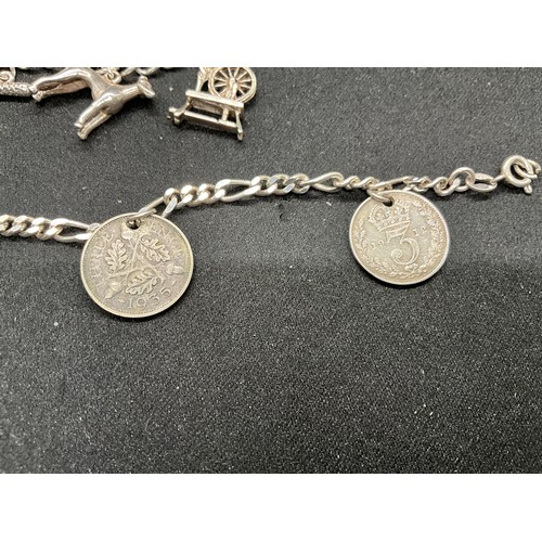 47 - 2 STERLING SILVER CHARM BRACELETS WITH 17 SILVER CHARMS W36.1G
CLASP ON ONE BRACELET IS PLATED, LOCK... 