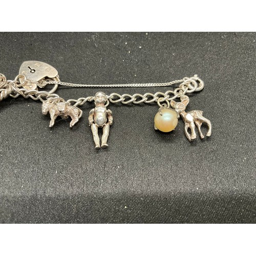 47 - 2 STERLING SILVER CHARM BRACELETS WITH 17 SILVER CHARMS W36.1G
CLASP ON ONE BRACELET IS PLATED, LOCK... 