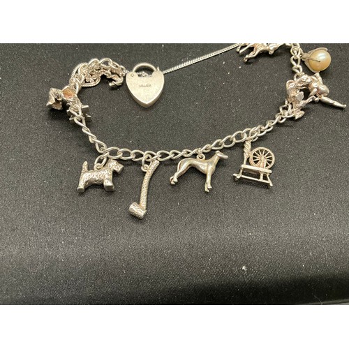 47 - 2 STERLING SILVER CHARM BRACELETS WITH 17 SILVER CHARMS W36.1G
CLASP ON ONE BRACELET IS PLATED, LOCK... 