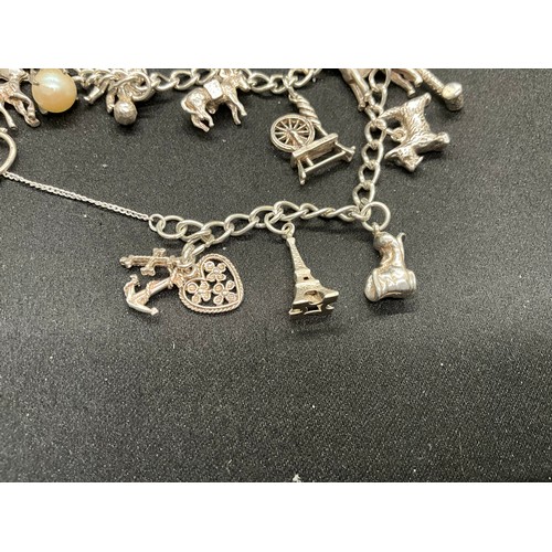47 - 2 STERLING SILVER CHARM BRACELETS WITH 17 SILVER CHARMS W36.1G
CLASP ON ONE BRACELET IS PLATED, LOCK... 