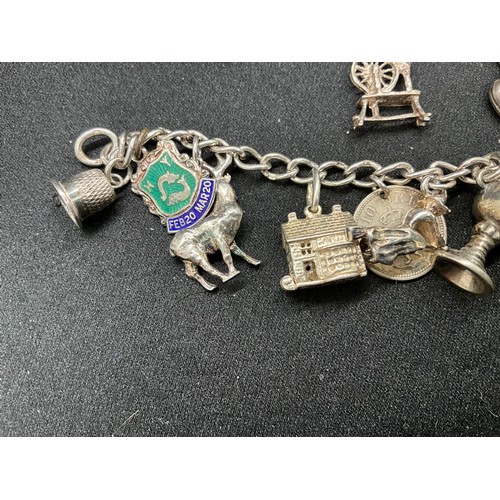 49 - 2 SILVER CHARM BRACELETS (TESTED) WITH A TOTAL OF 25 SILVER & WHITE METAL CHARMS TW69.6G - 1 LOCKET ... 