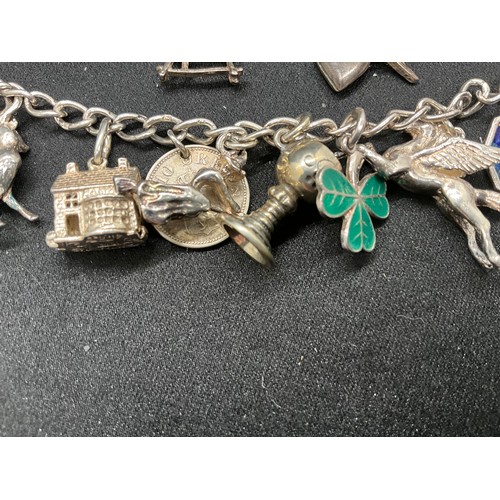 49 - 2 SILVER CHARM BRACELETS (TESTED) WITH A TOTAL OF 25 SILVER & WHITE METAL CHARMS TW69.6G - 1 LOCKET ... 