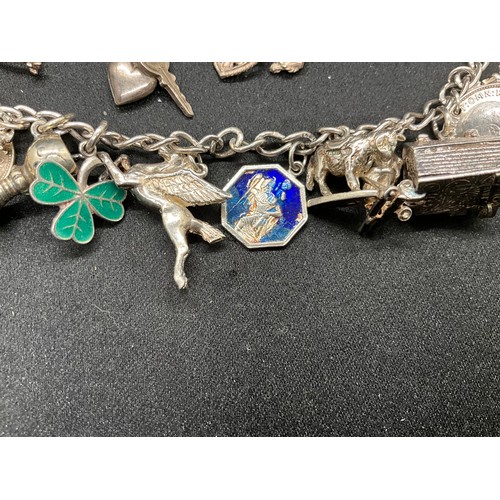 49 - 2 SILVER CHARM BRACELETS (TESTED) WITH A TOTAL OF 25 SILVER & WHITE METAL CHARMS TW69.6G - 1 LOCKET ... 