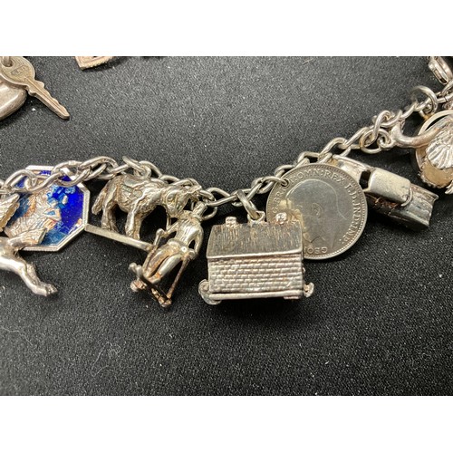 49 - 2 SILVER CHARM BRACELETS (TESTED) WITH A TOTAL OF 25 SILVER & WHITE METAL CHARMS TW69.6G - 1 LOCKET ... 