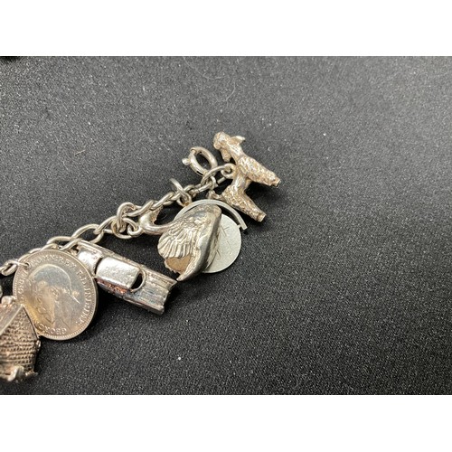 49 - 2 SILVER CHARM BRACELETS (TESTED) WITH A TOTAL OF 25 SILVER & WHITE METAL CHARMS TW69.6G - 1 LOCKET ... 