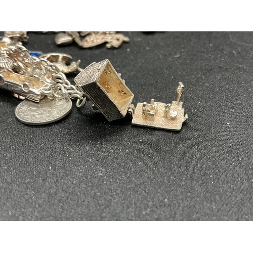 49 - 2 SILVER CHARM BRACELETS (TESTED) WITH A TOTAL OF 25 SILVER & WHITE METAL CHARMS TW69.6G - 1 LOCKET ... 