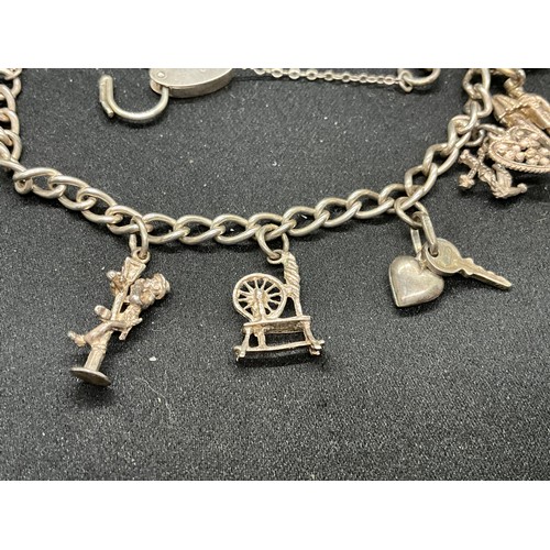 49 - 2 SILVER CHARM BRACELETS (TESTED) WITH A TOTAL OF 25 SILVER & WHITE METAL CHARMS TW69.6G - 1 LOCKET ... 