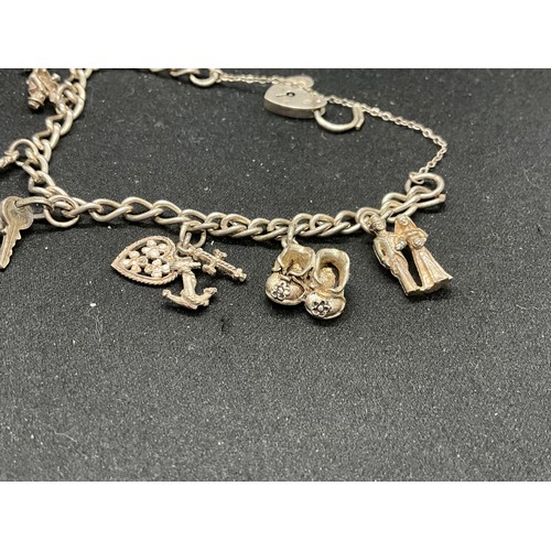 49 - 2 SILVER CHARM BRACELETS (TESTED) WITH A TOTAL OF 25 SILVER & WHITE METAL CHARMS TW69.6G - 1 LOCKET ... 