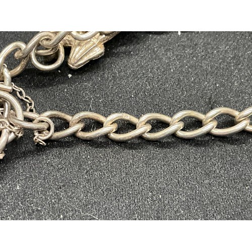 49 - 2 SILVER CHARM BRACELETS (TESTED) WITH A TOTAL OF 25 SILVER & WHITE METAL CHARMS TW69.6G - 1 LOCKET ... 