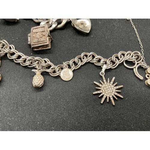 51 - 2 SILVER CHARM BRACELETS (TESTED) WITH A TOTAL OF 12 SILVER & WHITE METAL CHARMS TW62.4G - 1 CLASP I... 