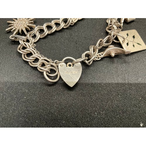 51 - 2 SILVER CHARM BRACELETS (TESTED) WITH A TOTAL OF 12 SILVER & WHITE METAL CHARMS TW62.4G - 1 CLASP I... 