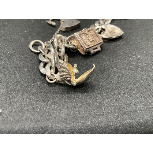 51 - 2 SILVER CHARM BRACELETS (TESTED) WITH A TOTAL OF 12 SILVER & WHITE METAL CHARMS TW62.4G - 1 CLASP I... 