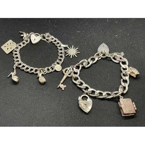 51 - 2 SILVER CHARM BRACELETS (TESTED) WITH A TOTAL OF 12 SILVER & WHITE METAL CHARMS TW62.4G - 1 CLASP I... 