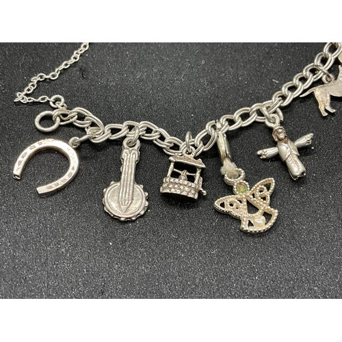 52 - 2 SILVER CHARM BRACELETS (TESTED) WITH A TOTAL OF 20 SILVER & WHITE METAL CHARMS W38.4G - BOTH LOCKE... 
