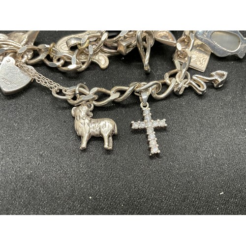 54 - 2 SILVER CHARM BRACELETS (TESTED) WITH A TOTAL OF 20 SILVER & WHITE METAL CHARMS TW60.6G - 1 HOOP HO... 