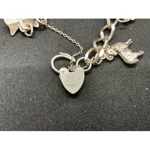 54 - 2 SILVER CHARM BRACELETS (TESTED) WITH A TOTAL OF 20 SILVER & WHITE METAL CHARMS TW60.6G - 1 HOOP HO... 