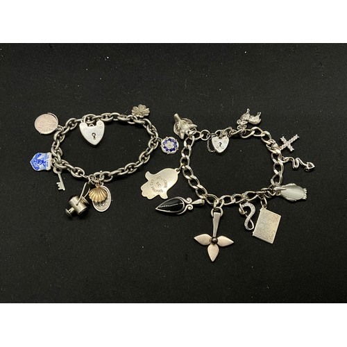 54 - 2 SILVER CHARM BRACELETS (TESTED) WITH A TOTAL OF 20 SILVER & WHITE METAL CHARMS TW60.6G - 1 HOOP HO... 