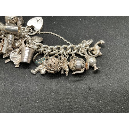 55 - SILVER CHARM BRACELET (TESTED) WITH 30 SILVER & WHITE METAL CHARMS TW110.7G - ENGLISH HALLMARK LOCKE... 