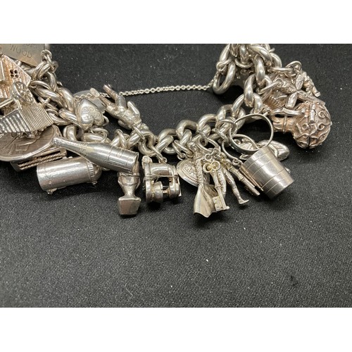 55 - SILVER CHARM BRACELET (TESTED) WITH 30 SILVER & WHITE METAL CHARMS TW110.7G - ENGLISH HALLMARK LOCKE... 