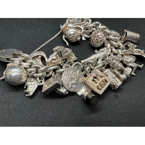55 - SILVER CHARM BRACELET (TESTED) WITH 30 SILVER & WHITE METAL CHARMS TW110.7G - ENGLISH HALLMARK LOCKE... 