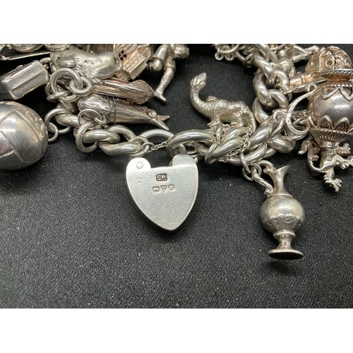 55 - SILVER CHARM BRACELET (TESTED) WITH 30 SILVER & WHITE METAL CHARMS TW110.7G - ENGLISH HALLMARK LOCKE... 