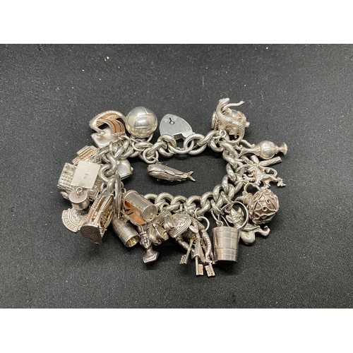 55 - SILVER CHARM BRACELET (TESTED) WITH 30 SILVER & WHITE METAL CHARMS TW110.7G - ENGLISH HALLMARK LOCKE... 