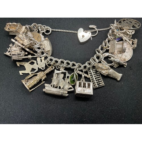 57 - SILVER CHARM BRACELET (TESTED) WITH 23 SILVER & WHITE METAL CHARMS AND 1 COIN CHARM PLATED W72.5G -L... 