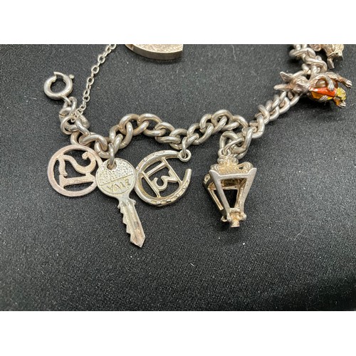 58 - 2 SILVER CHARM BRACELETS (TESTED) WITH A TOTAL OF 25 SILVER & WHITE METAL CHARMS ADDITIONAL CHARM PL... 