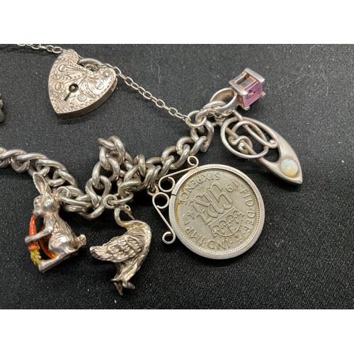 58 - 2 SILVER CHARM BRACELETS (TESTED) WITH A TOTAL OF 25 SILVER & WHITE METAL CHARMS ADDITIONAL CHARM PL... 