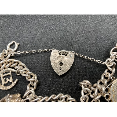 58 - 2 SILVER CHARM BRACELETS (TESTED) WITH A TOTAL OF 25 SILVER & WHITE METAL CHARMS ADDITIONAL CHARM PL... 