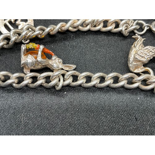 58 - 2 SILVER CHARM BRACELETS (TESTED) WITH A TOTAL OF 25 SILVER & WHITE METAL CHARMS ADDITIONAL CHARM PL... 