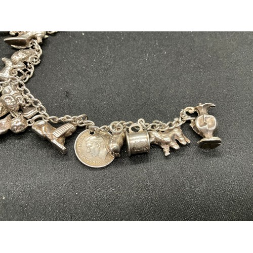 58 - 2 SILVER CHARM BRACELETS (TESTED) WITH A TOTAL OF 25 SILVER & WHITE METAL CHARMS ADDITIONAL CHARM PL... 