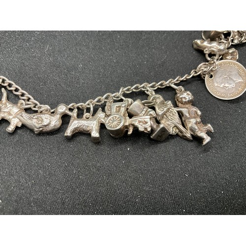 58 - 2 SILVER CHARM BRACELETS (TESTED) WITH A TOTAL OF 25 SILVER & WHITE METAL CHARMS ADDITIONAL CHARM PL... 